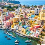 Panoramic view of colorful fisherman houses by the sea in Procida, a perfect addition to your Amalfi Coast guide.
