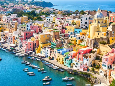 Panoramic view of colorful fisherman houses by the sea in Procida, a perfect addition to your Amalfi Coast guide.