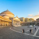 The stunning Piazza del Plebiscito illuminated during golden hour, one of the top things to do in Naples.